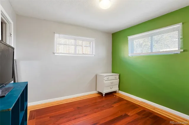 a view of room with window and wooden floor
