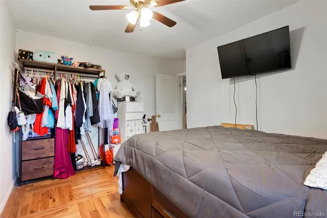 a bedroom with a bed and a flat tv screen