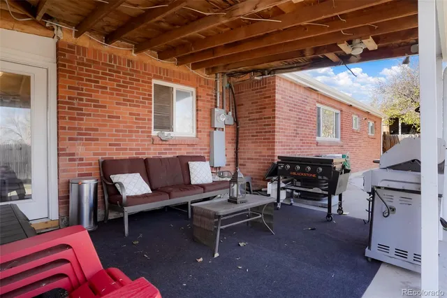 a outdoor space with patio couch and a barbeque