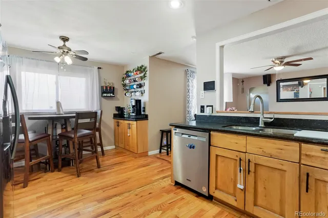 a kitchen with granite countertop a sink appliances cabinets and dining table