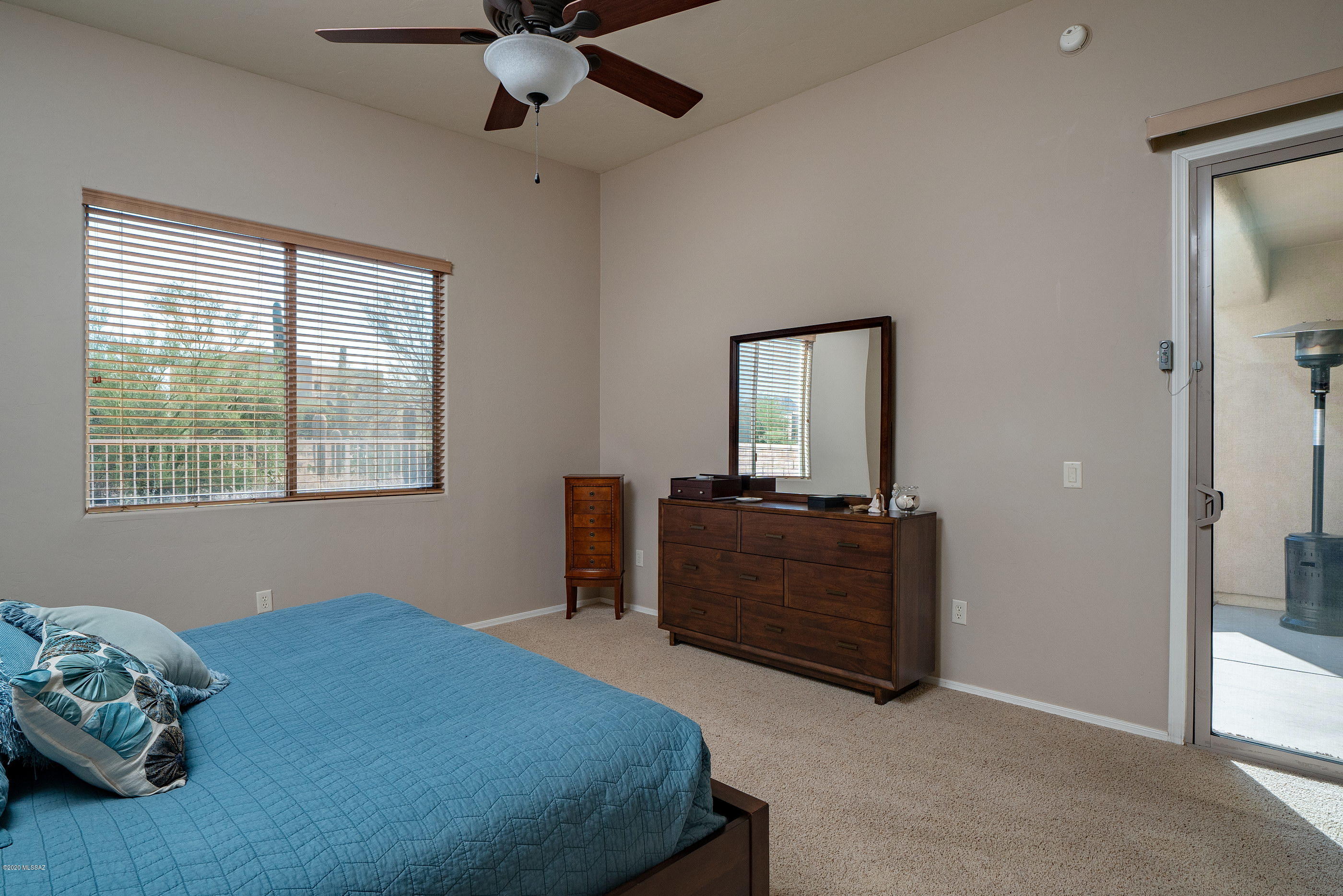 4440 West Crystal Ranch Place Marana, AZ 85658 - Photo 24 of 28 a bedroom with a bed and a mirror