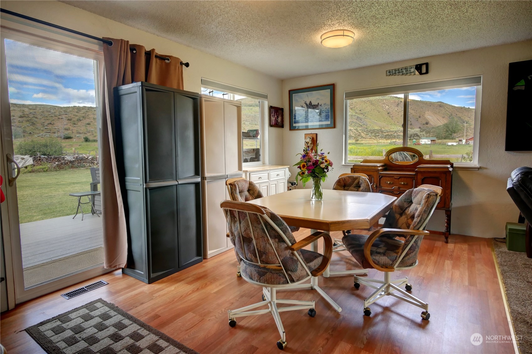 20325A State Rte 20, Unit A Twisp, WA 98856 - Photo 14 of 34 a dining room with furniture a chandelier and wooden floor