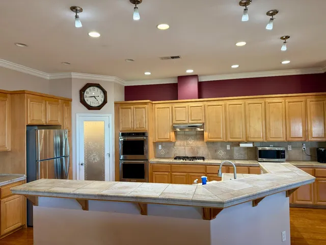 a dining room with wooden floor and furniture