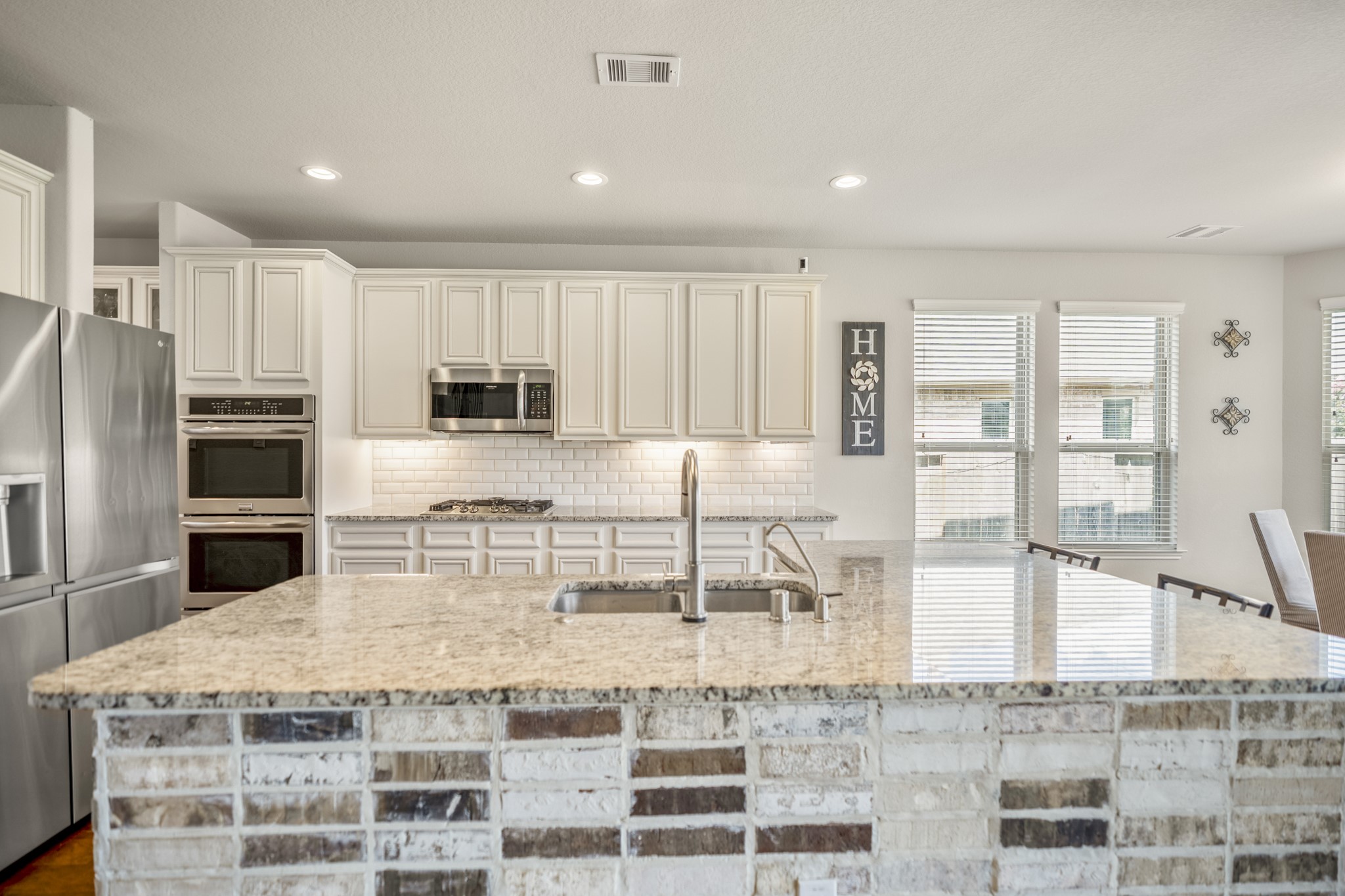 23006 Mulberry Tree Lane Spring, TX 77389 - Photo 18 of 50 a kitchen with kitchen island granite countertop a large counter top stainless steel appliances and cabinets