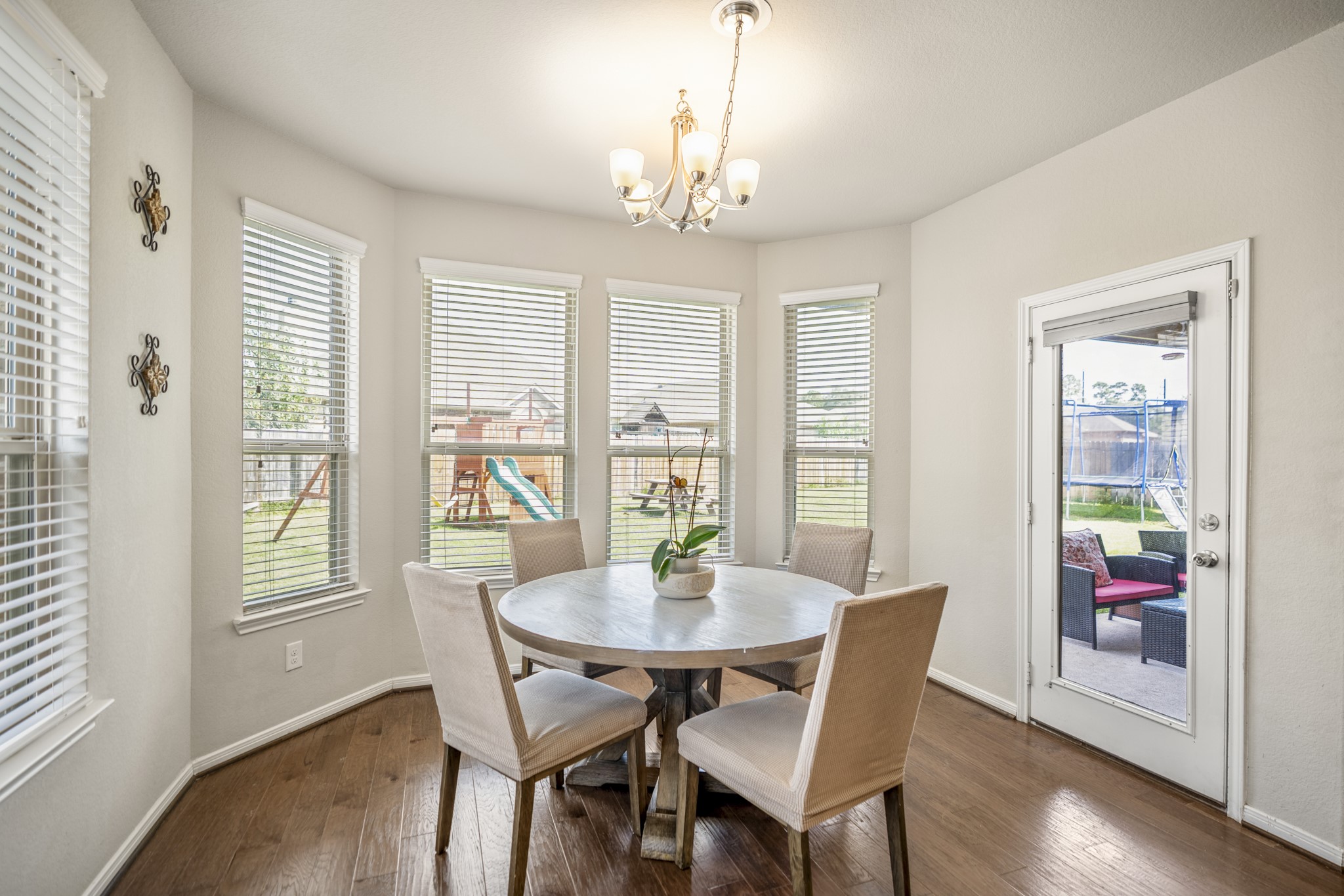 23006 Mulberry Tree Lane Spring, TX 77389 - Photo 19 of 50 a dining room with furniture a chandelier and wooden floor