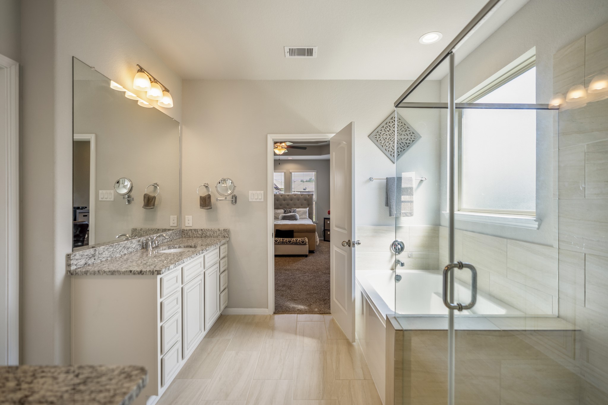 23006 Mulberry Tree Lane Spring, TX 77389 - Photo 25 of 50 a bathroom with a granite countertop sink a mirror and shower