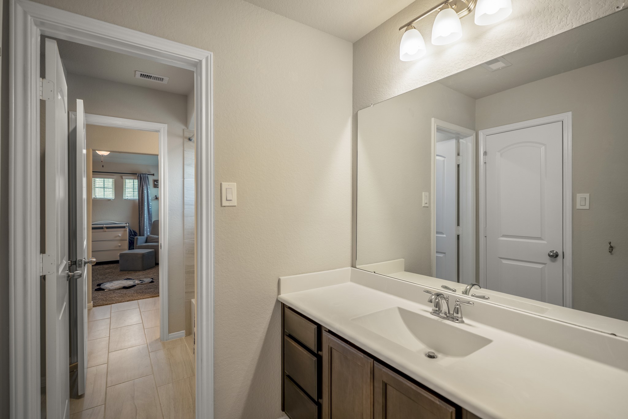 23006 Mulberry Tree Lane Spring, TX 77389 - Photo 35 of 50 a bathroom with a sink vanity and a mirror