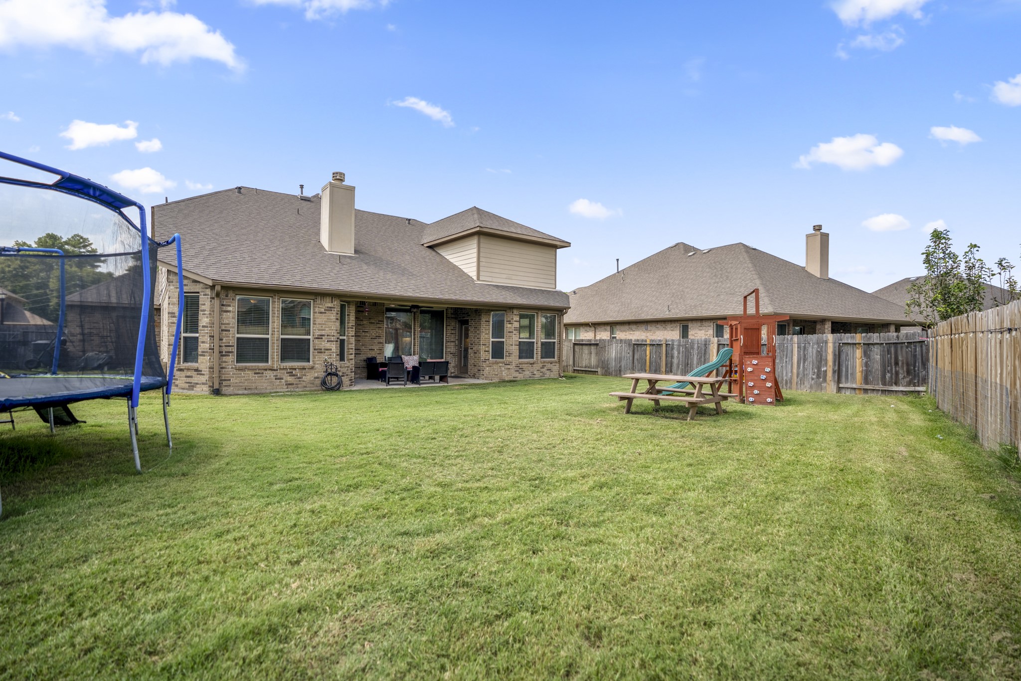 23006 Mulberry Tree Lane Spring, TX 77389 - Photo 42 of 50 a front view of a house with a yard table and chairs