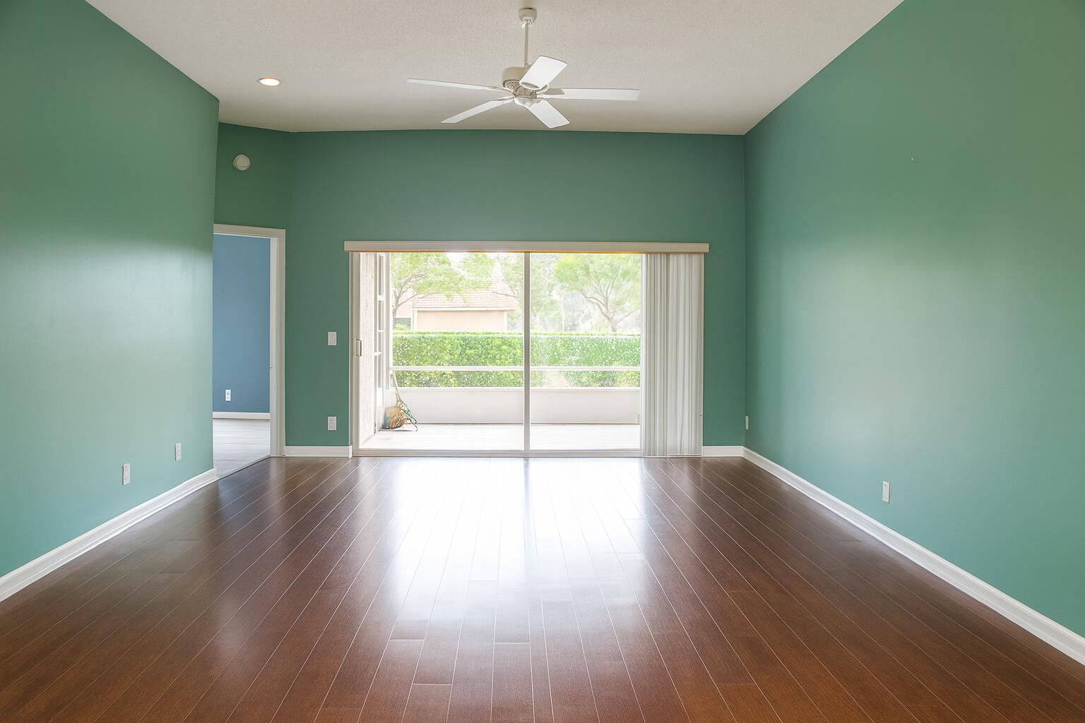6387 Long Key Lane Boynton Beach, FL 33472 - Photo 13 of 49 a view of an empty room with wooden floor and fan