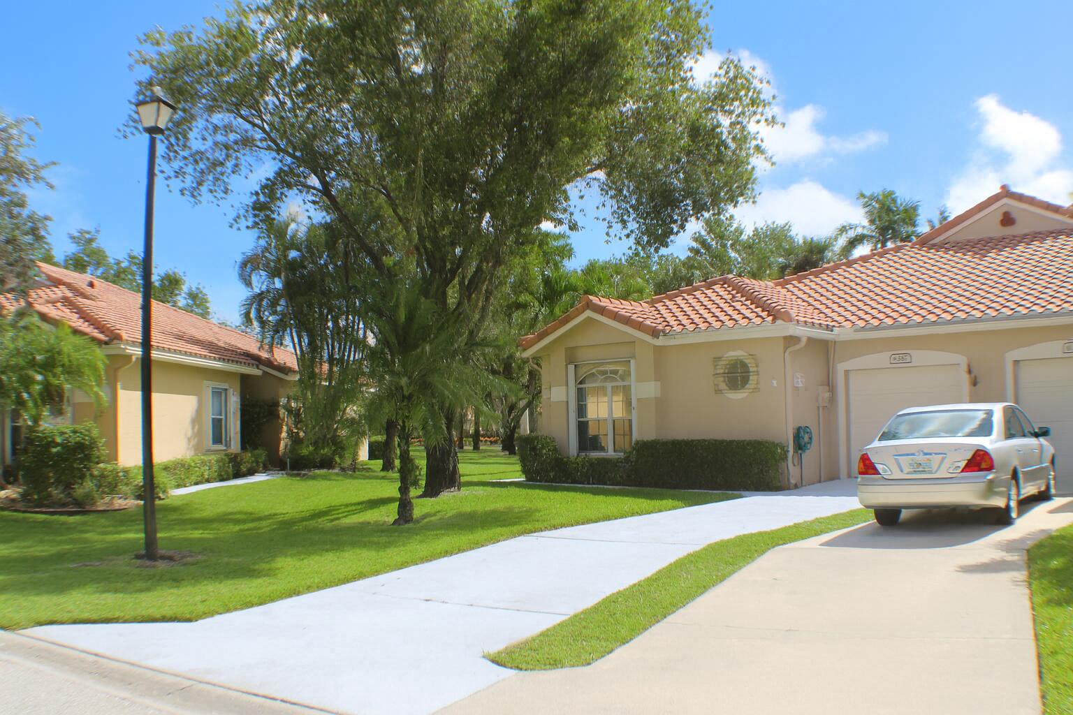 6387 Long Key Lane Boynton Beach, FL 33472 - Photo 2 of 49 a front view of a house with a yard