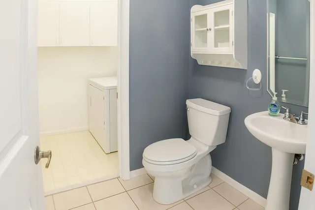 a bathroom with a toilet sink and mirror