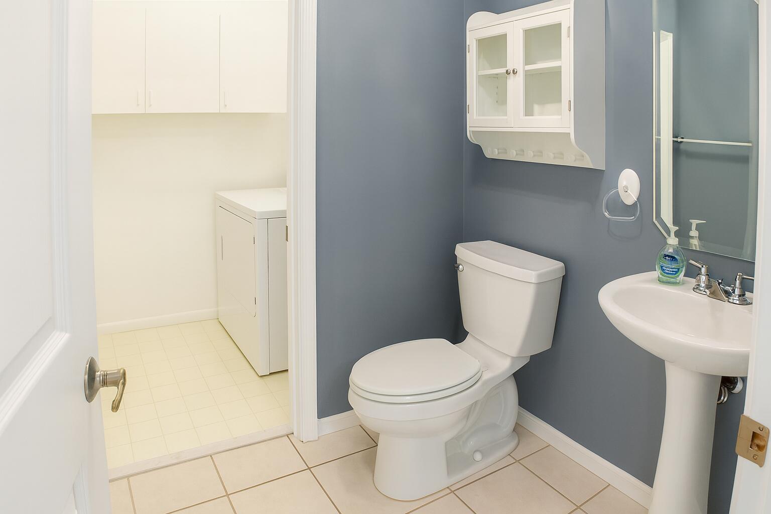 6387 Long Key Lane Boynton Beach, FL 33472 - Photo 26 of 49 a white toilet sitting next to a bathroom sink