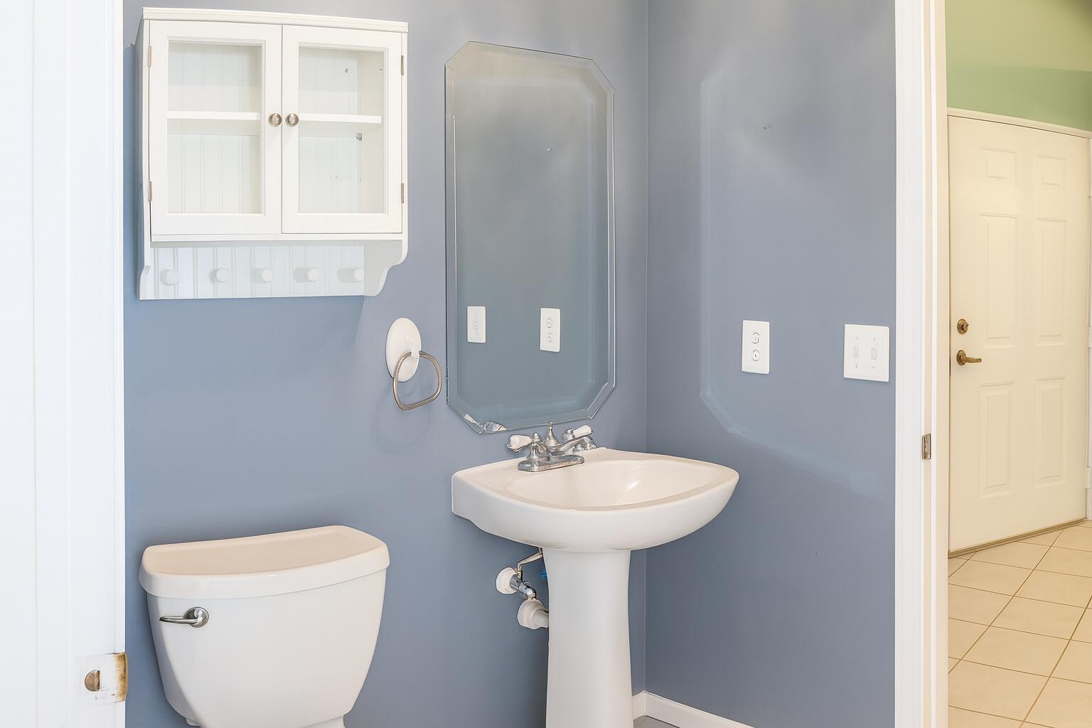 6387 Long Key Lane Boynton Beach, FL 33472 - Photo 27 of 49 a bathroom with a toilet sink and mirror