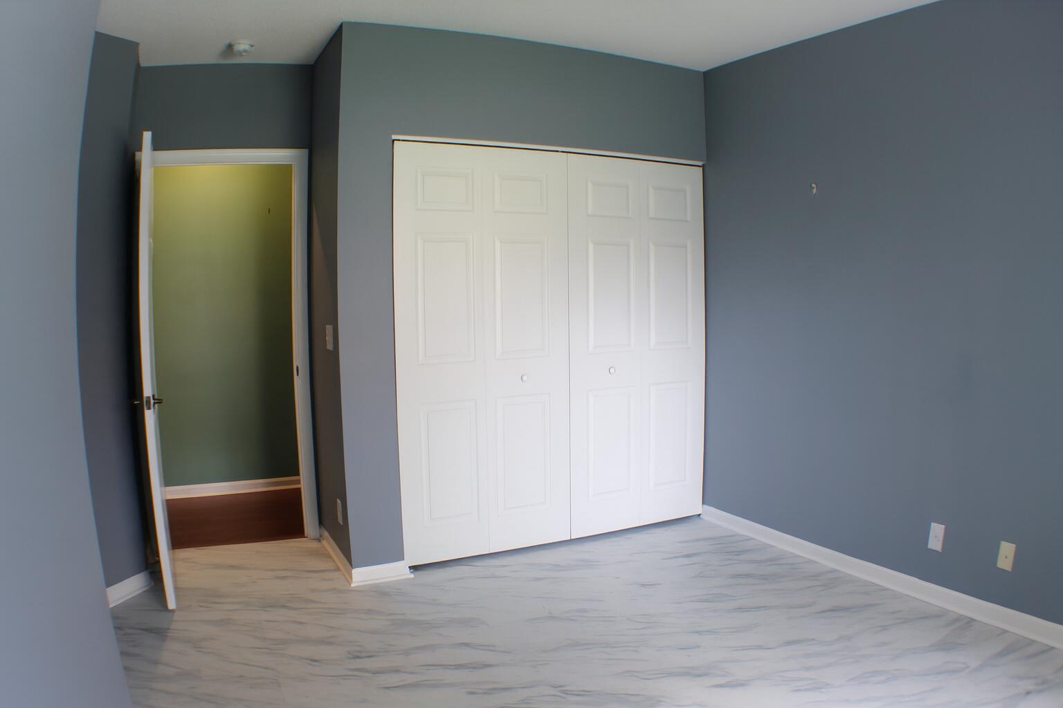 6387 Long Key Lane Boynton Beach, FL 33472 - Photo 32 of 49 a view of an empty room with wooden floor and closet