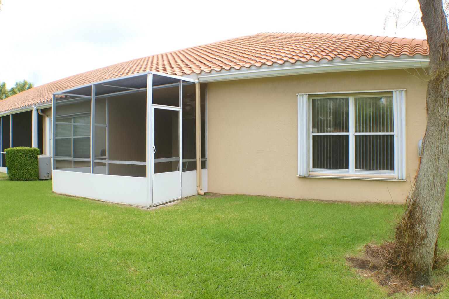 6387 Long Key Lane Boynton Beach, FL 33472 - Photo 39 of 49 a view of front door of house with yard