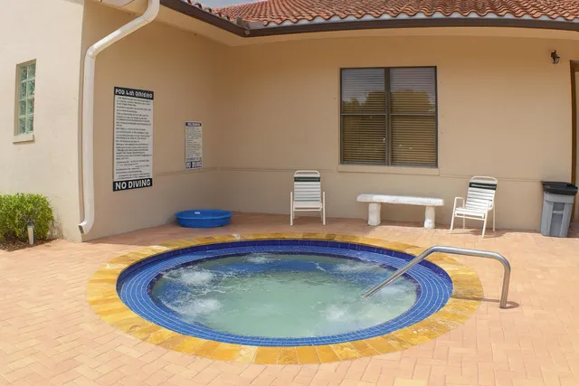 a view of a patio with a table and chairs under an umbrella