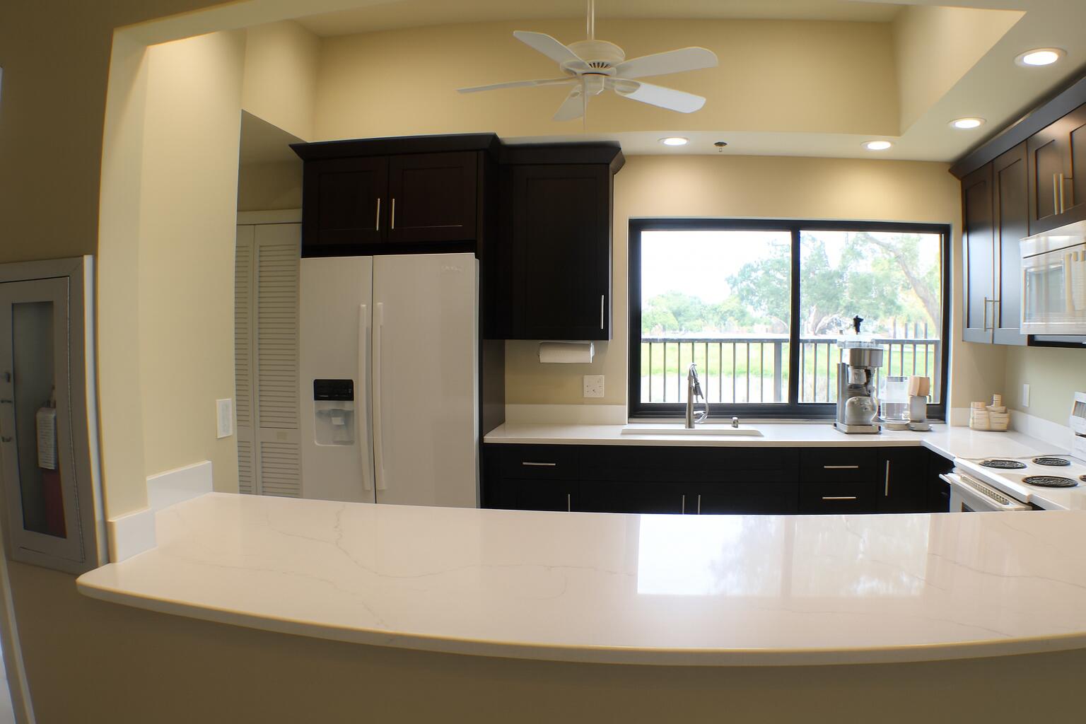 6387 Long Key Lane Boynton Beach, FL 33472 - Photo 48 of 49 a large white kitchen with a large window