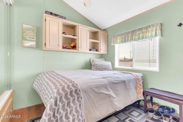 a bedroom with a bed and a window