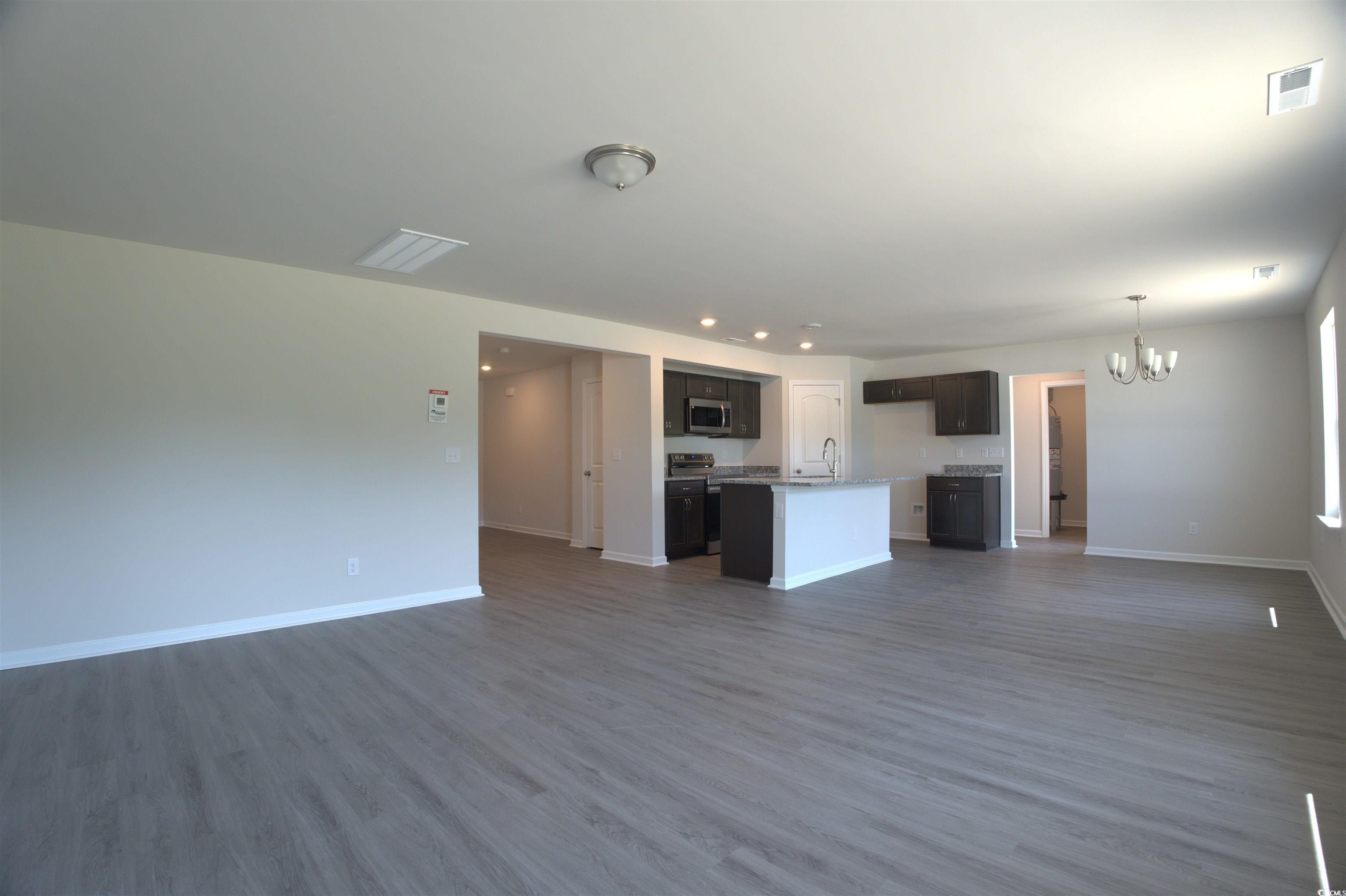 1494 Hardwick Road Conway, SC 29526 - Photo 17 of 33 Unfurnished living room with a chandelier, dark wo