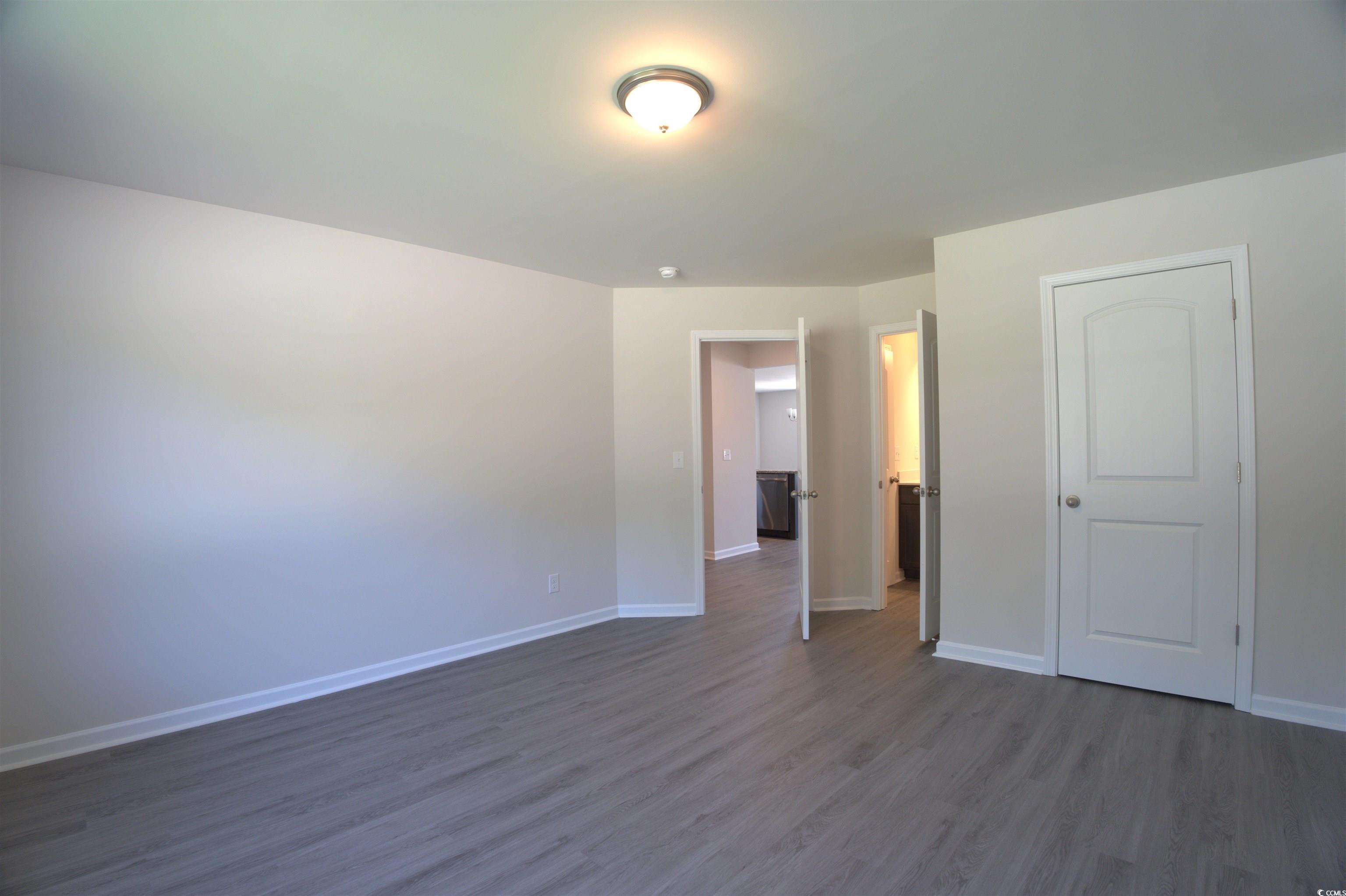 1494 Hardwick Road Conway, SC 29526 - Photo 18 of 33 Unfurnished living room with a chandelier, dark wo