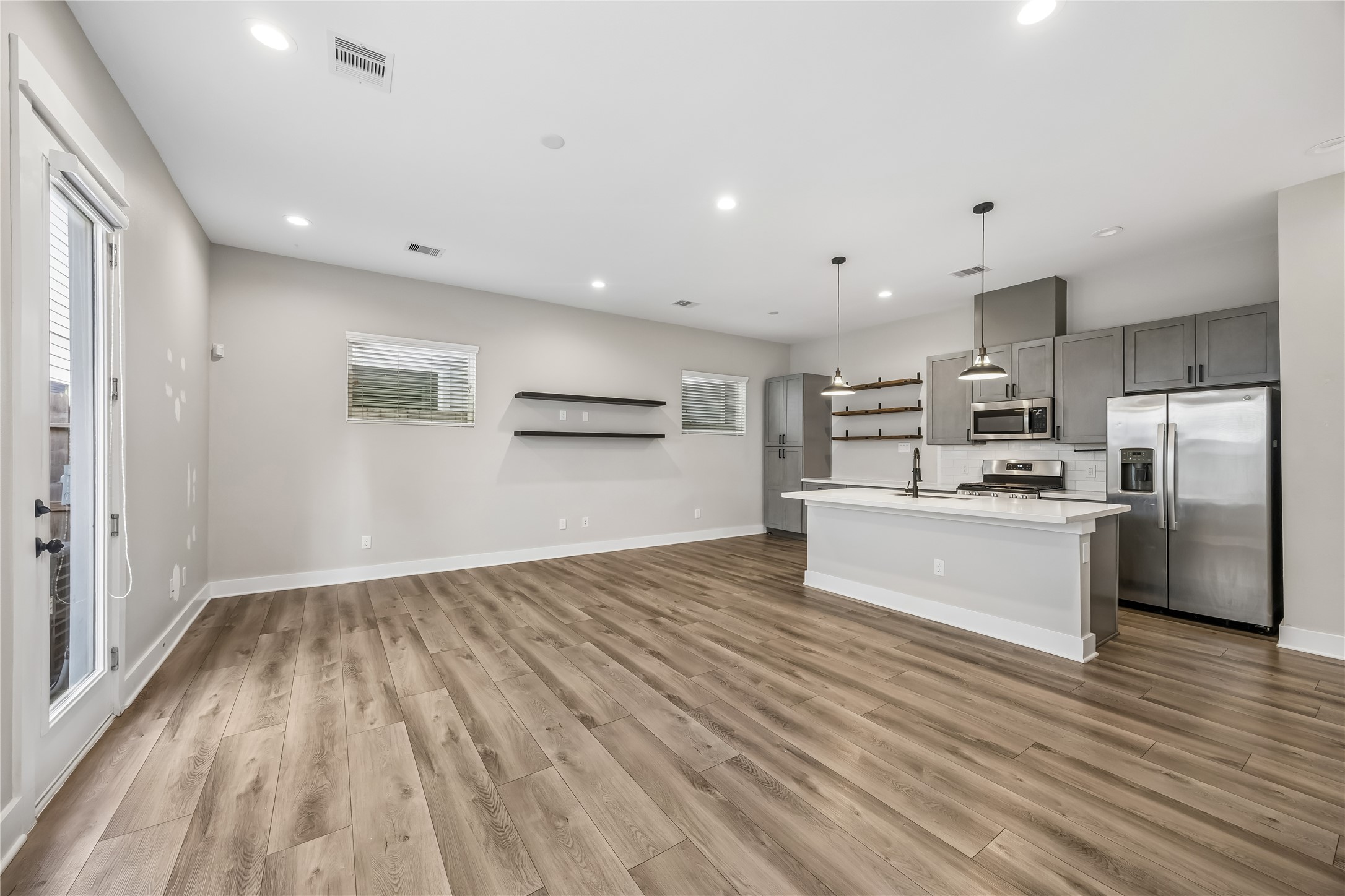 1209 West Tidwell Road Houston, TX 77091 - Photo 5 of 25 Another view of the living space. See recessed lighting and pendant lights.