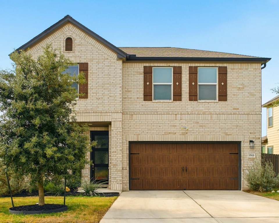 a front view of a house with a yard