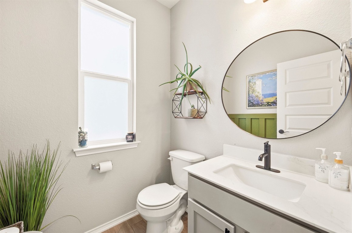 1506 Dragonfly Loop Bastrop, TX 78602 - Photo 13 of 37 a bathroom with a sink a mirror and a toilet