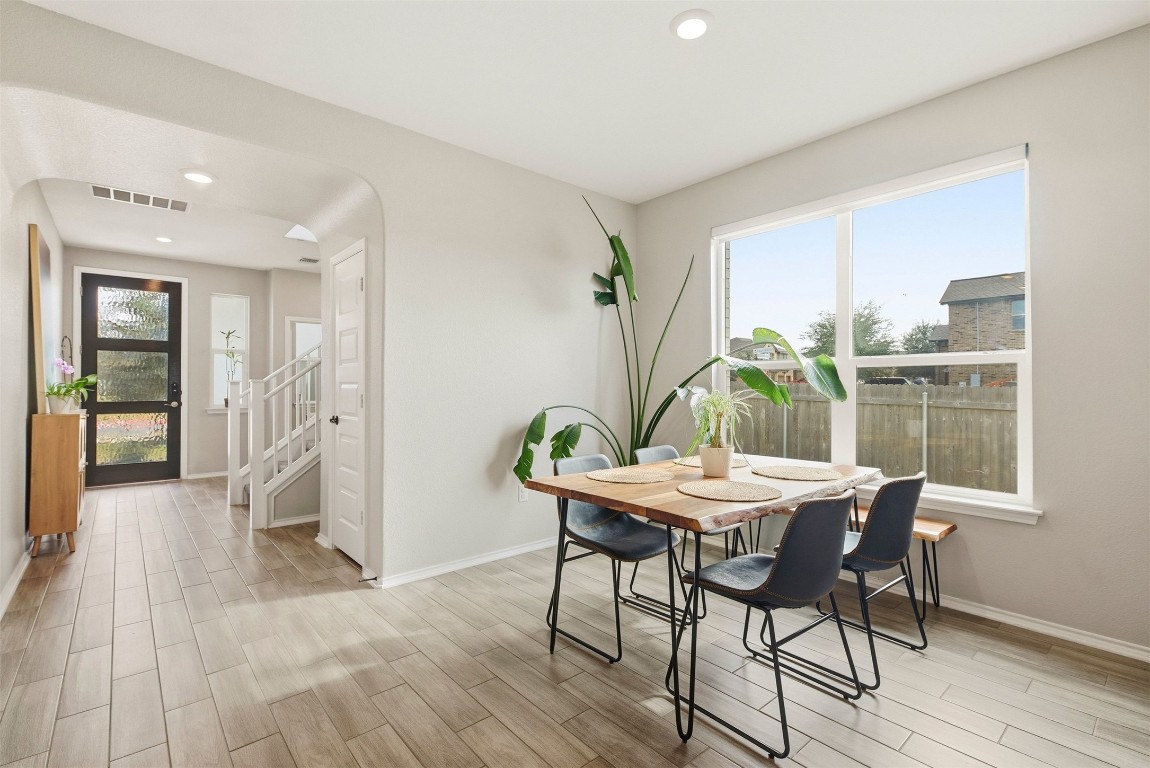 1506 Dragonfly Loop Bastrop, TX 78602 - Photo 3 of 37 a view of a dining room with furniture window and wooden floor