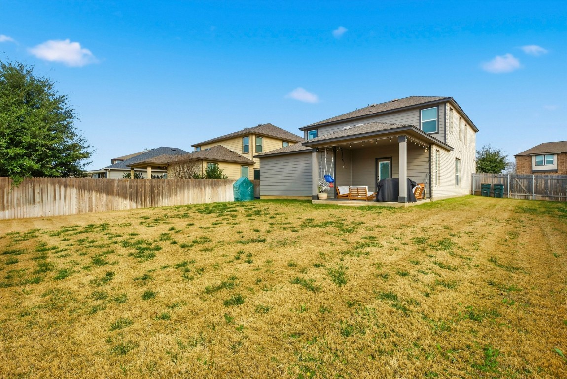1506 Dragonfly Loop Bastrop, TX 78602 - Photo 31 of 37 a front view of a house with a yard