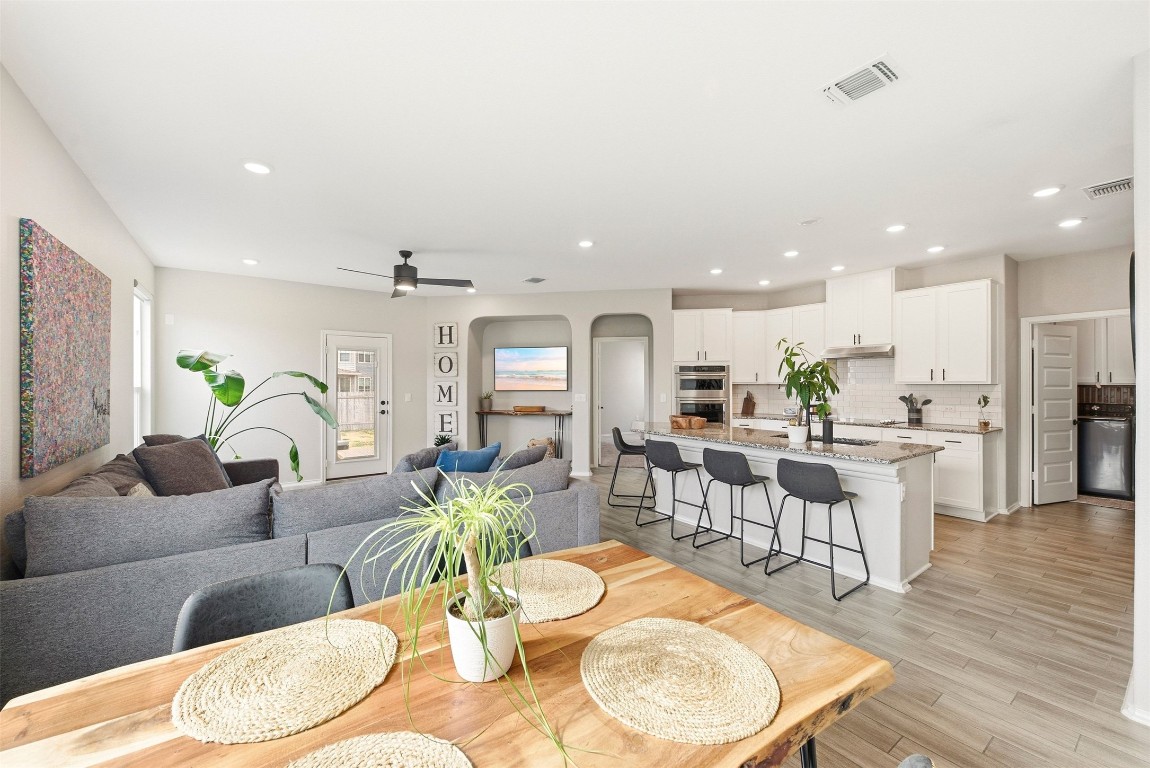 1506 Dragonfly Loop Bastrop, TX 78602 - Photo 4 of 37 a living room with furniture kitchen view and a dining table