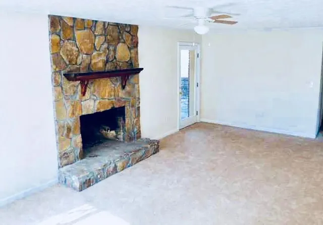 an empty room with fireplace