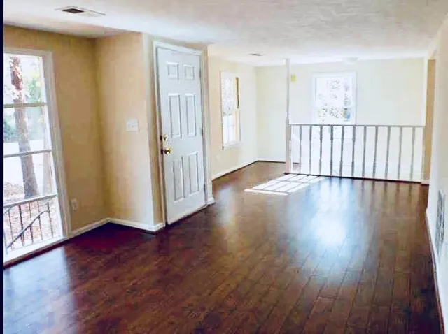 a view of a hallway with wooden floor