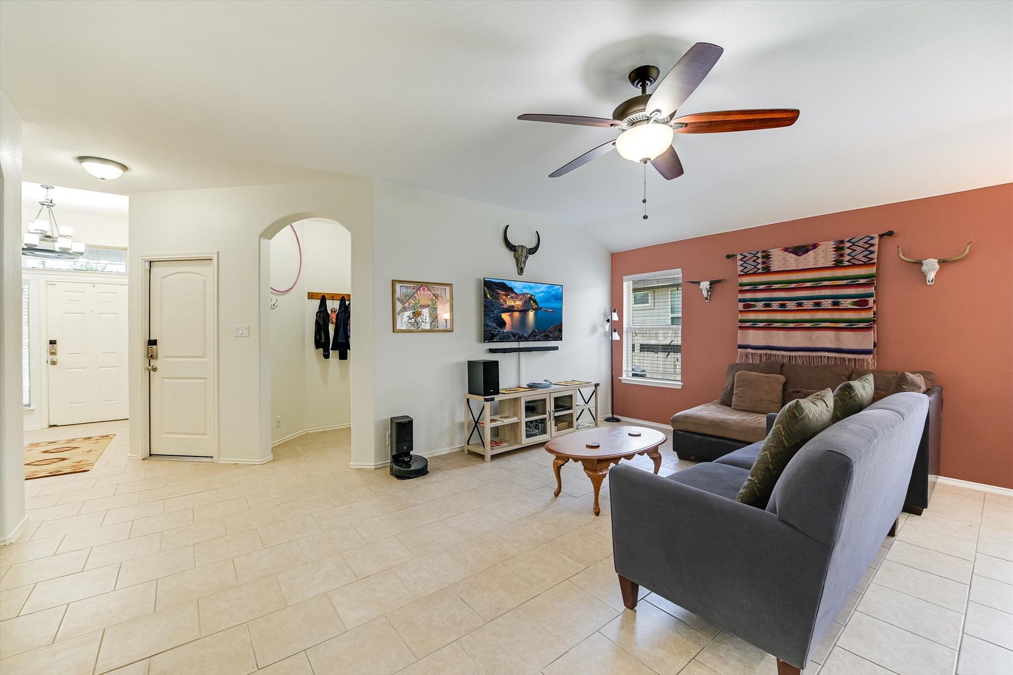 536 Dragon Ridge Road Buda, TX 78610 - Photo 4 of 20 Spacious living area featuring light-toned tile flooring, vaulted ceiling with a ceiling fan, and a neutral color palette