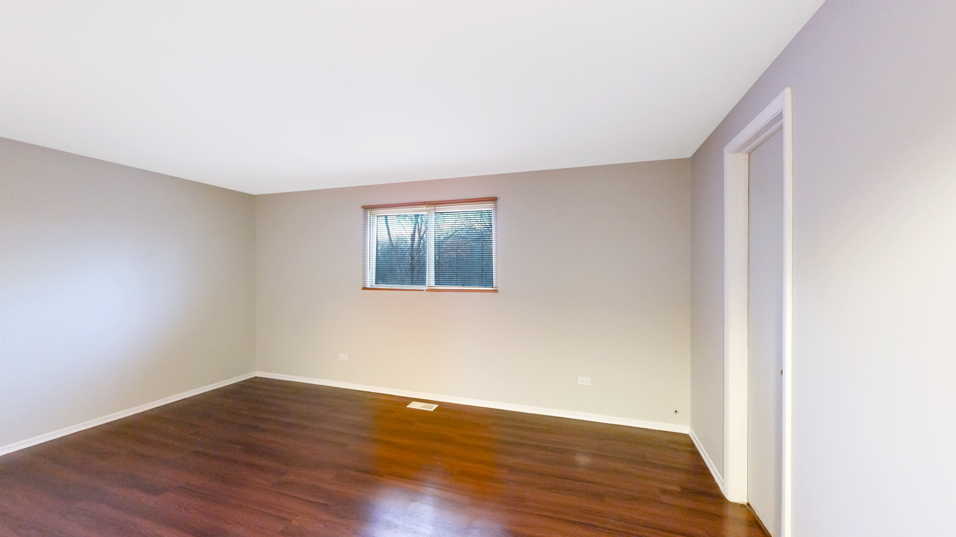 611 Andover Street Chicago Heights, IL 60411 - Photo 11 of 30 a view of an empty room with wooden floor and a window