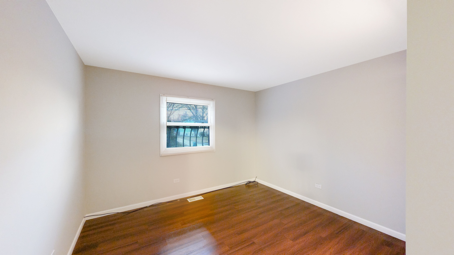 611 Andover Street Chicago Heights, IL 60411 - Photo 12 of 30 a view of an empty room with wooden floor and a window