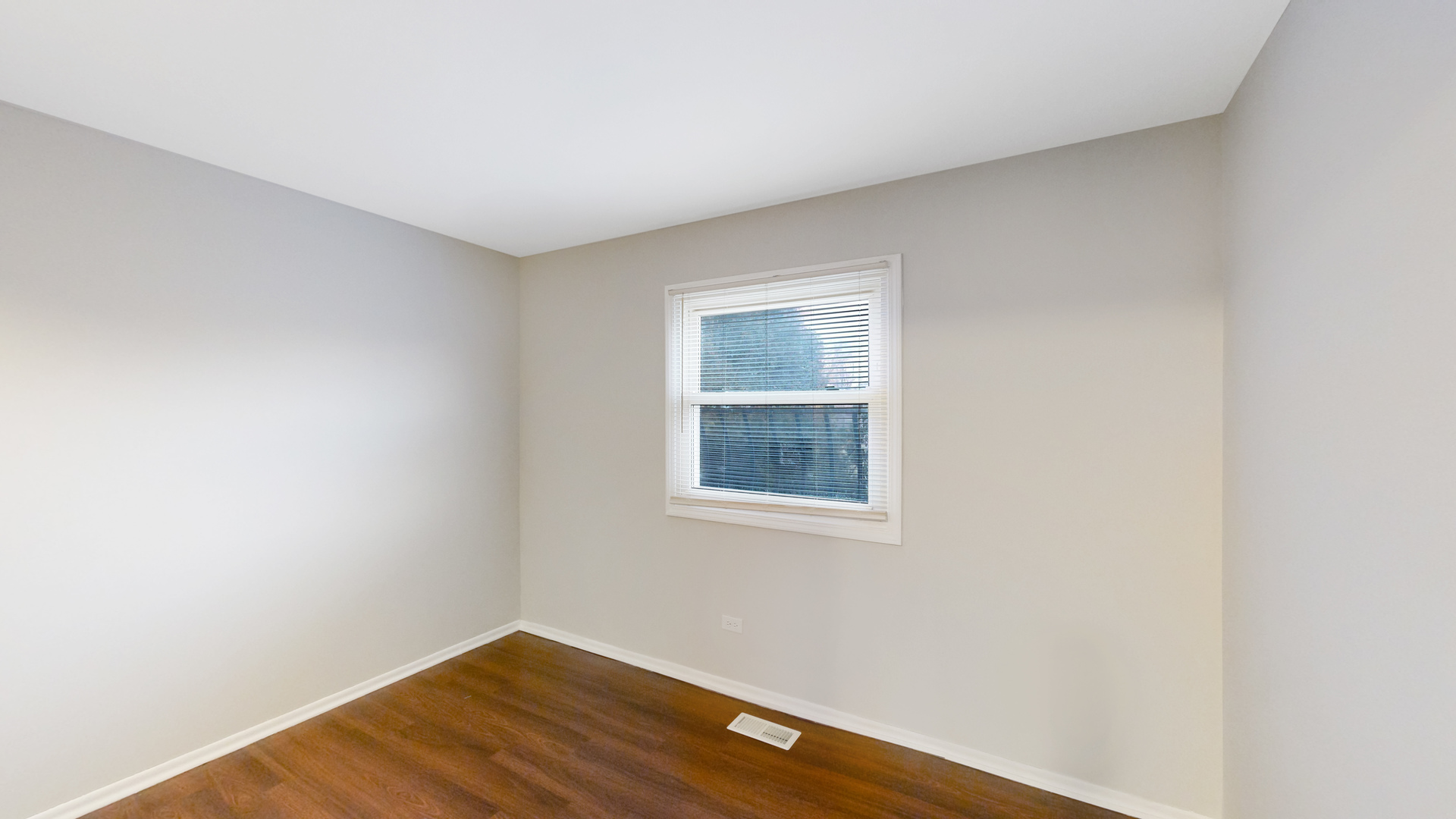 611 Andover Street Chicago Heights, IL 60411 - Photo 14 of 30 a view of an empty room with wooden floor and a window