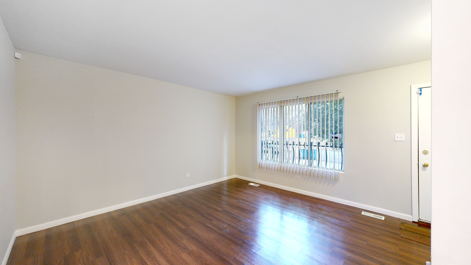 611 Andover Street Chicago Heights, IL 60411 - Photo 2 of 30 an empty room with wooden floor and windows