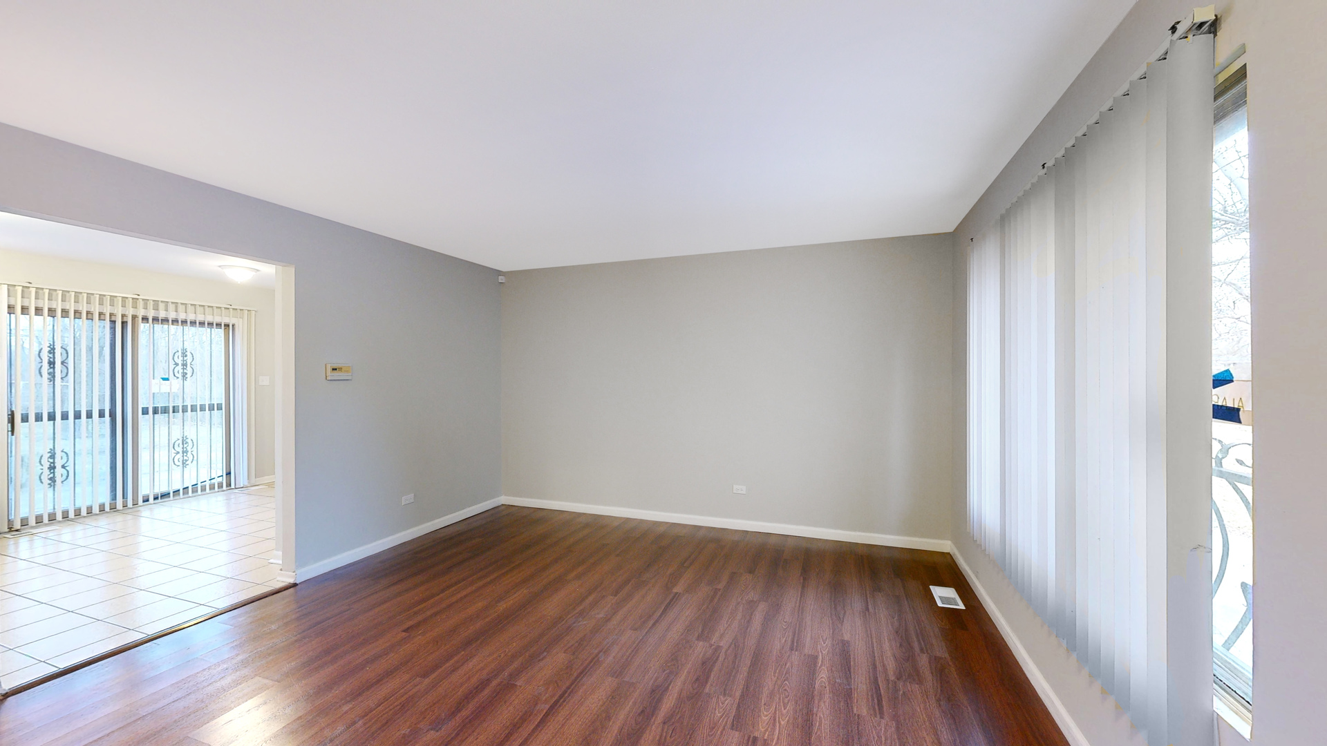 611 Andover Street Chicago Heights, IL 60411 - Photo 3 of 30 wooden floor in an empty room with a window