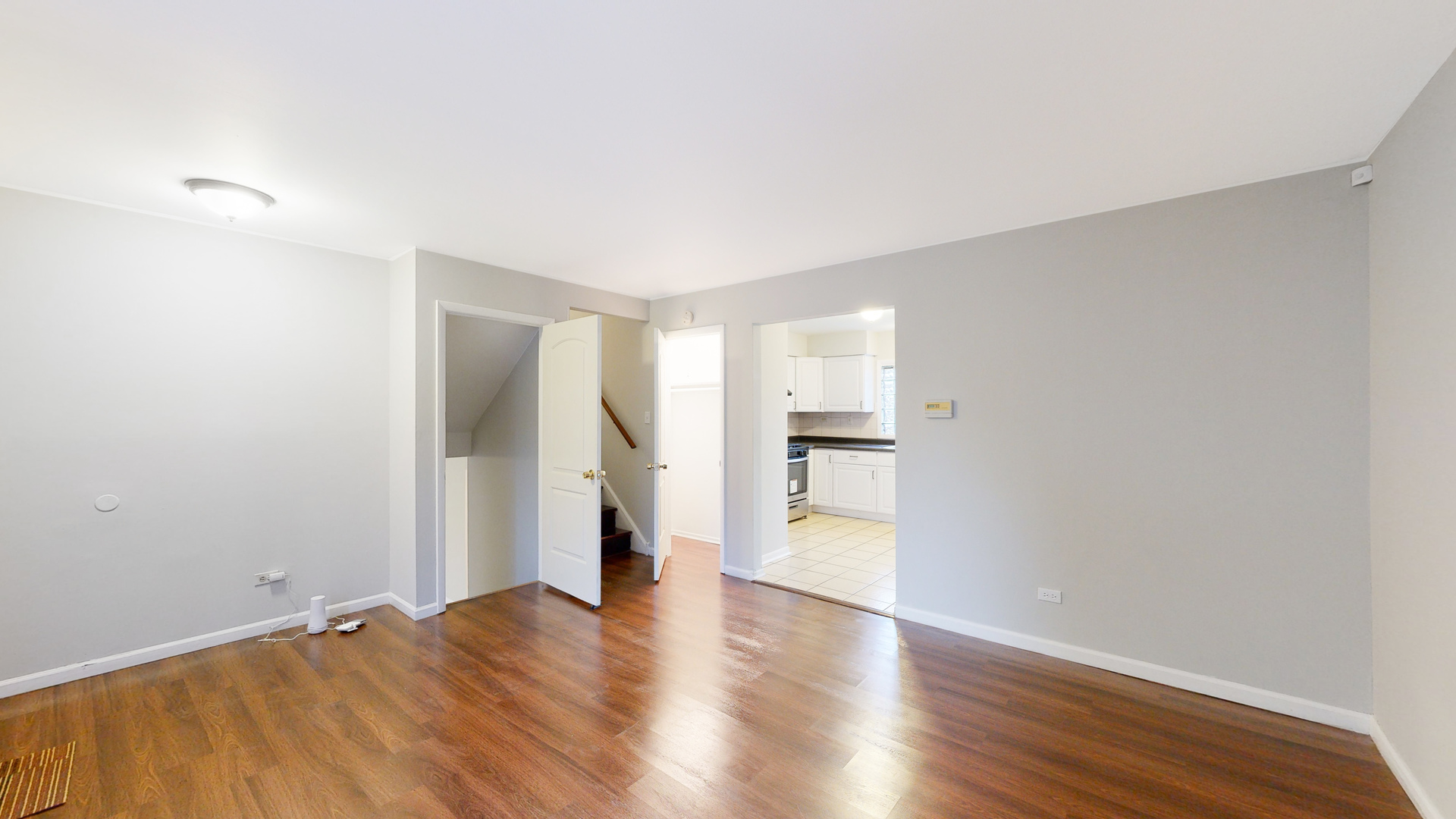 611 Andover Street Chicago Heights, IL 60411 - Photo 4 of 30 a view of empty room with wooden floor and windows