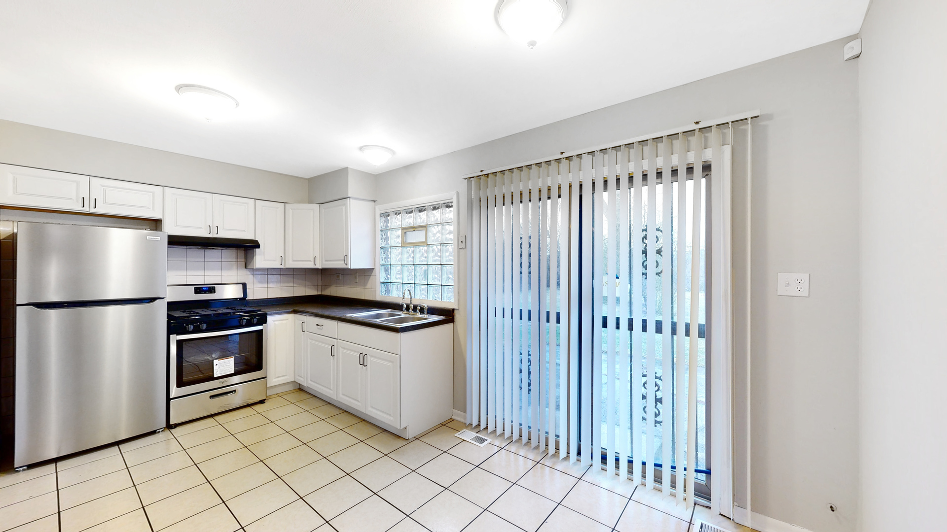611 Andover Street Chicago Heights, IL 60411 - Photo 6 of 30 a kitchen with stainless steel appliances granite countertop a refrigerator and a sink