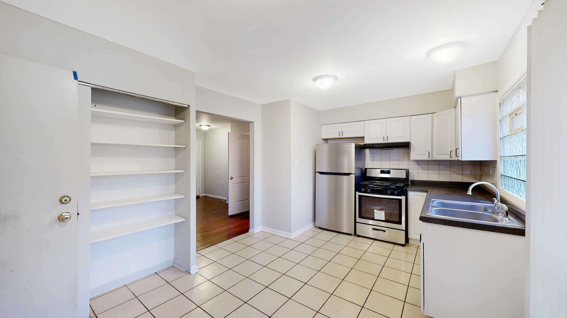 611 Andover Street Chicago Heights, IL 60411 - Photo 7 of 30 a kitchen with stainless steel appliances a refrigerator and a stove top oven