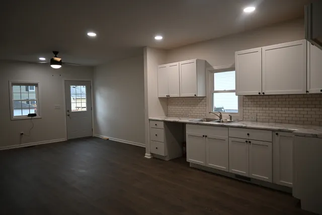 a kitchen that has a sink and cabinets in it