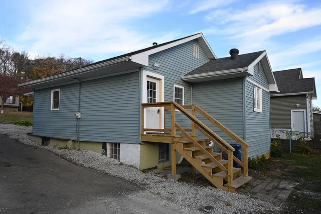 a backyard of a house with wooden roof and deck