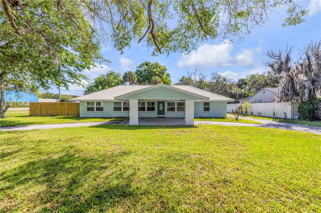 103 Flagler Avenue Edgewater, FL 32132 - Photo 1 of 53 a front view of house with yard and swimming pool