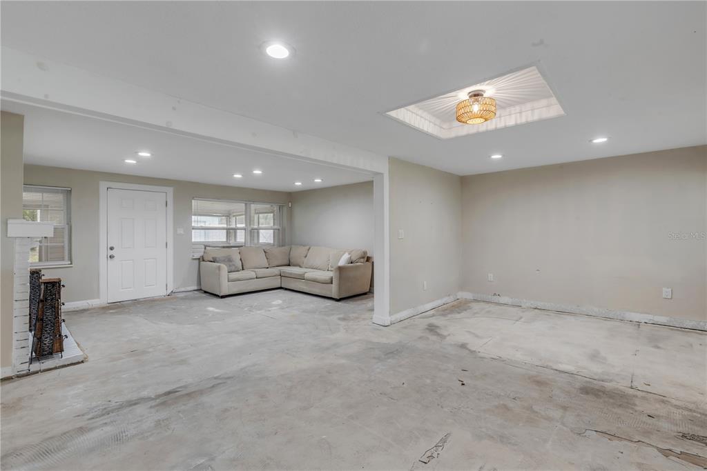 103 Flagler Avenue Edgewater, FL 32132 - Photo 11 of 53 a view of a room with gym equipment and a large window