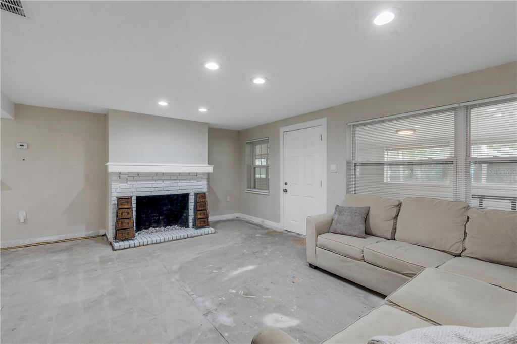 103 Flagler Avenue Edgewater, FL 32132 - Photo 15 of 53 a living room with furniture and a fireplace