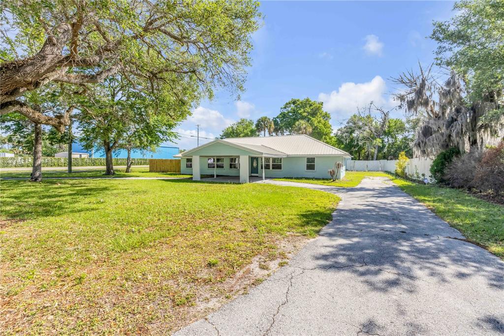103 Flagler Avenue Edgewater, FL 32132 - Photo 2 of 53 a view of an house with swimming pool and yard with green space