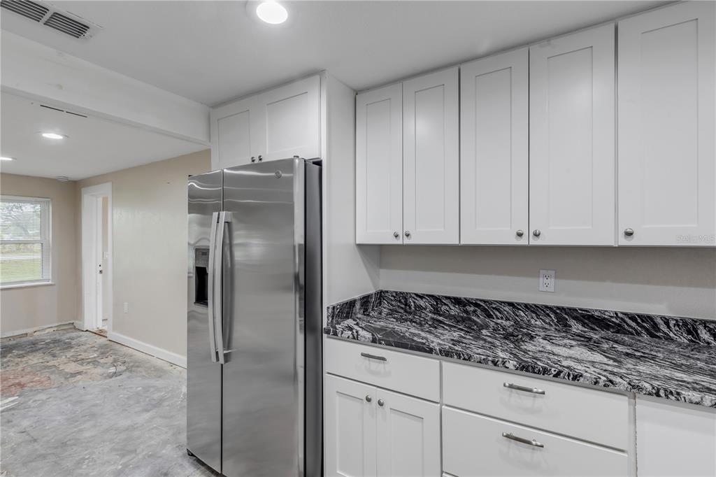 103 Flagler Avenue Edgewater, FL 32132 - Photo 28 of 53 a kitchen with stainless steel appliances granite countertop a refrigerator and a stove