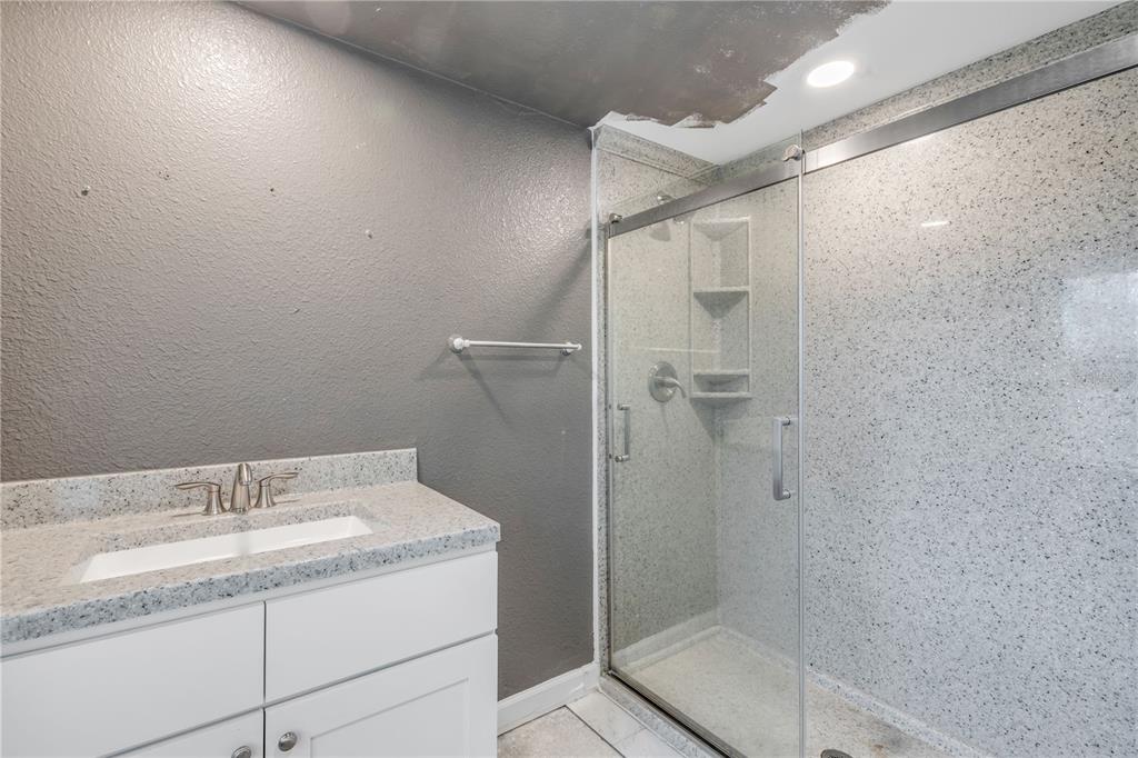103 Flagler Avenue Edgewater, FL 32132 - Photo 34 of 53 a bathroom with a granite countertop sink a shower and a mirror