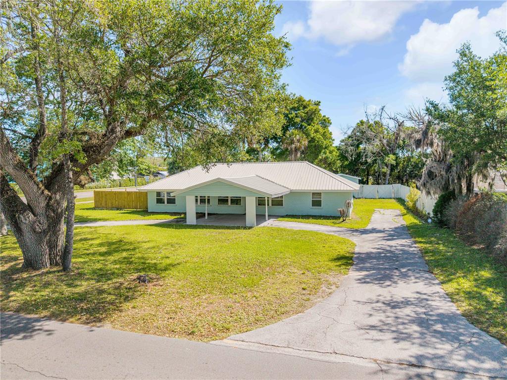 103 Flagler Avenue Edgewater, FL 32132 - Photo 6 of 53 a yellow swimming pool is in a backyard of a house